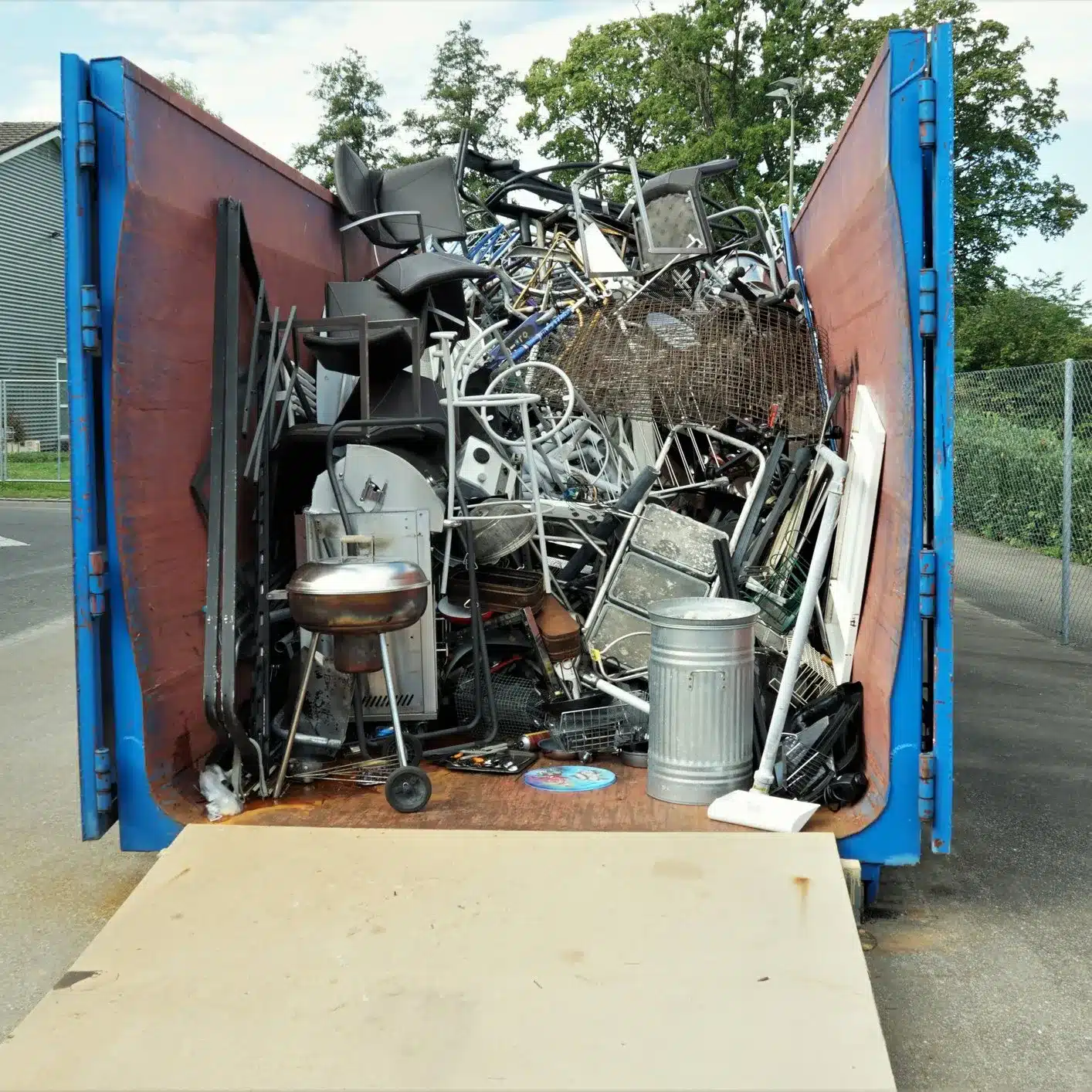 Blue Dumpster full of Metal